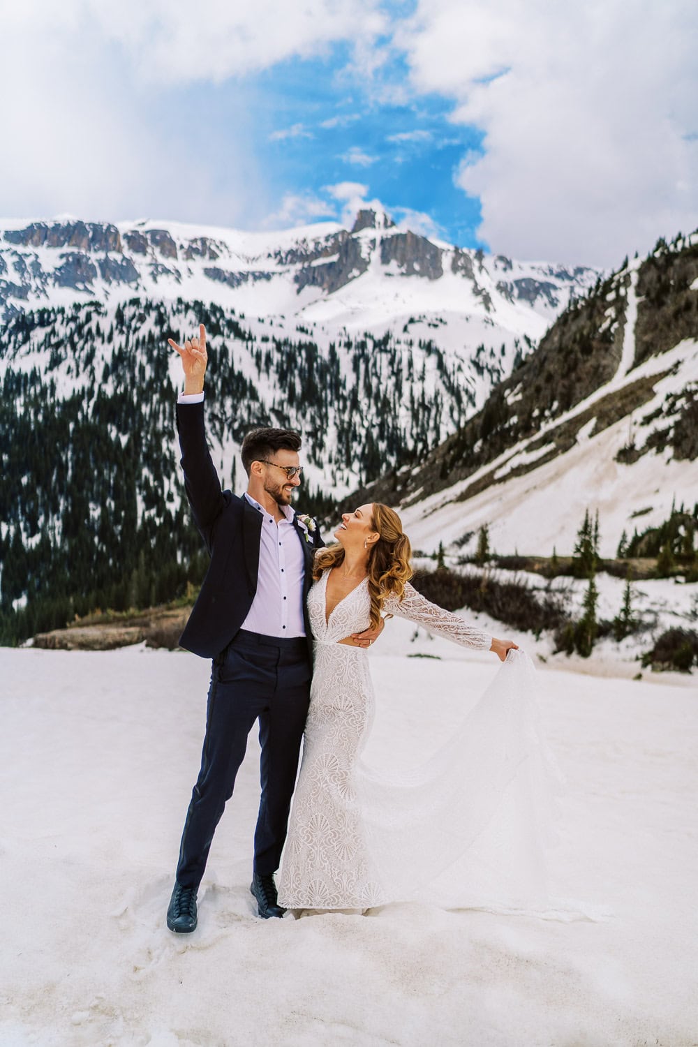 beautiful bride and groom pose in the Rocky Mountains outside Ouray, Colorado for a photo