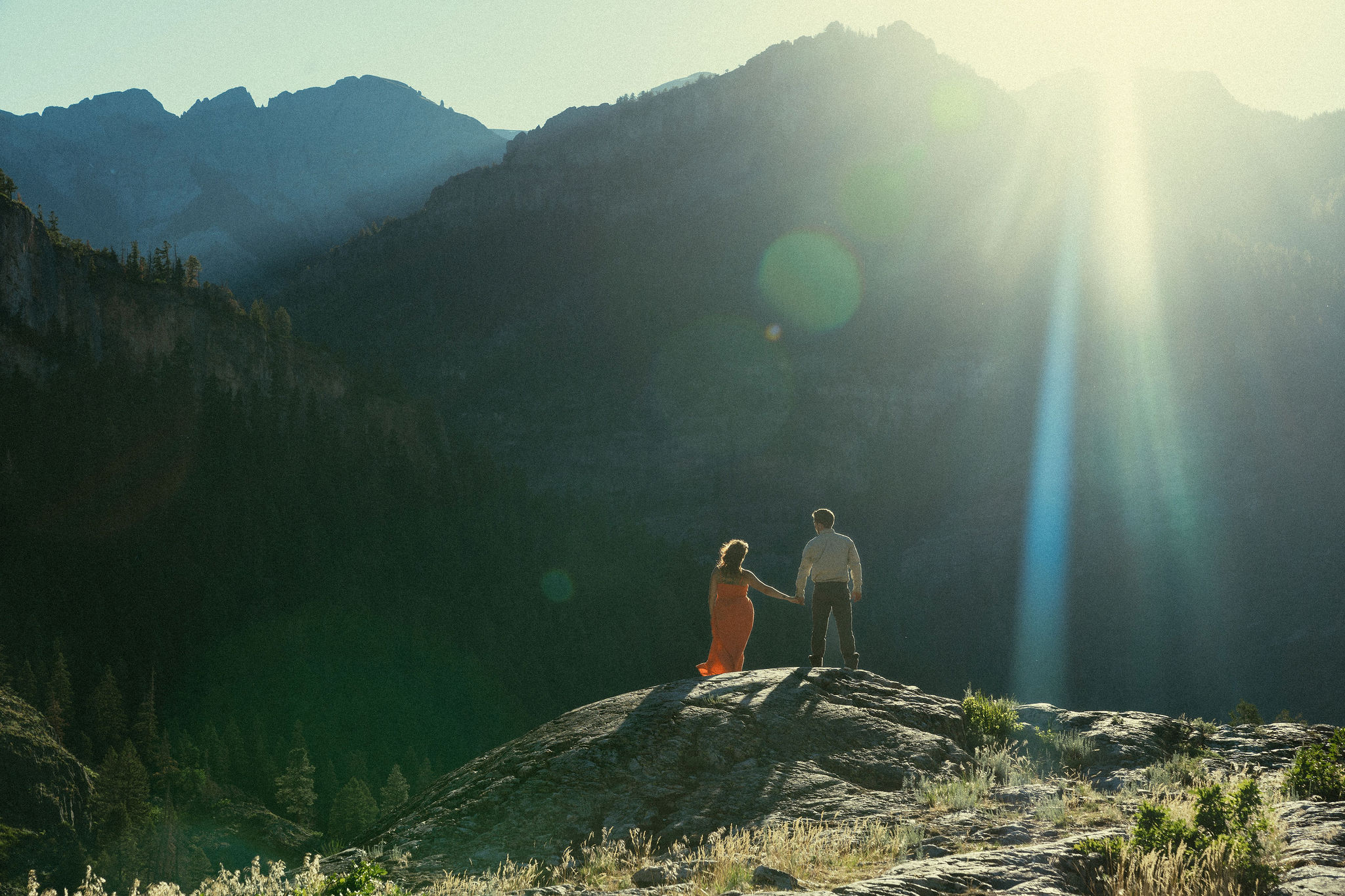 beautiful couple pose during their Ouray engagement photos with the Rocky mountains outside Ouray, Colorado