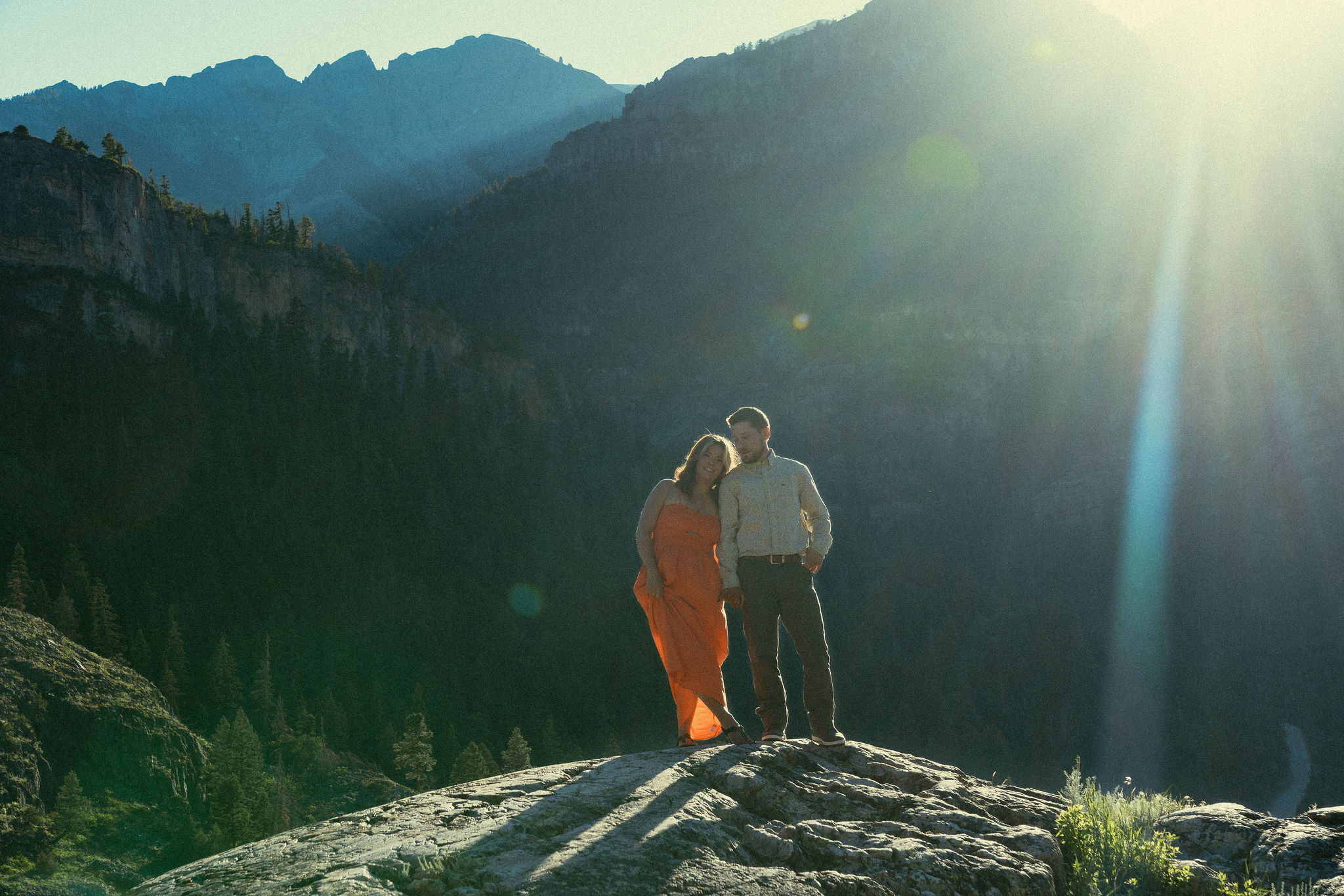 beautiful couple pose during their Ouray engagement photos with the Rocky mountains outside Ouray, Colorado