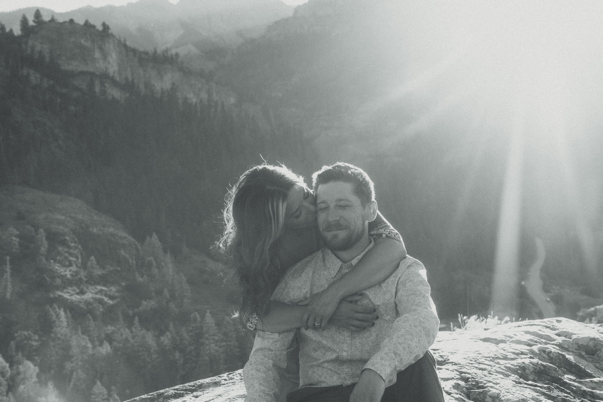 beautiful couple pose during their Ouray engagement photos with the Rocky mountains outside Ouray, Colorado