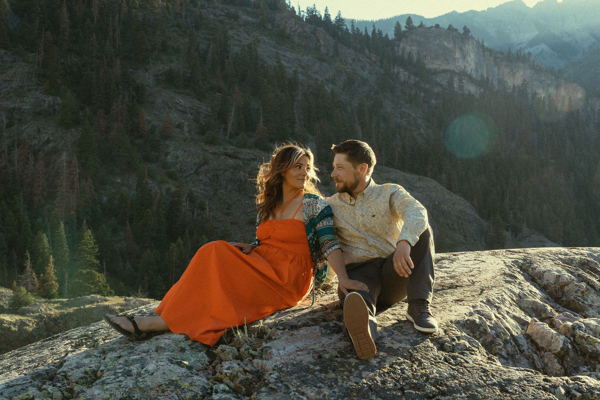 beautiful couple pose during their Ouray engagement photos with the Rocky mountains outside Ouray, Colorado