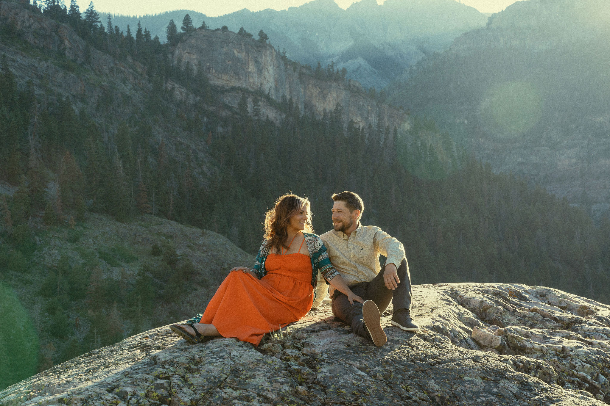 beautiful couple pose during their Ouray engagement photos with the Rocky mountains outside Ouray, Colorado