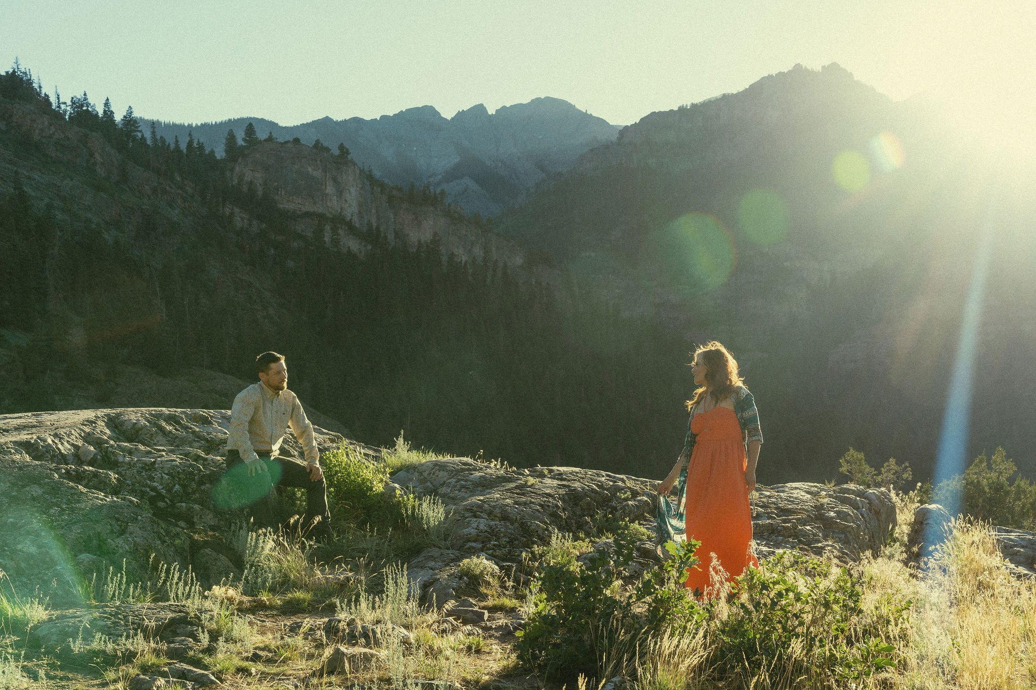 beautiful couple pose during their Ouray engagement photos with the Rocky mountains outside Ouray, Colorado