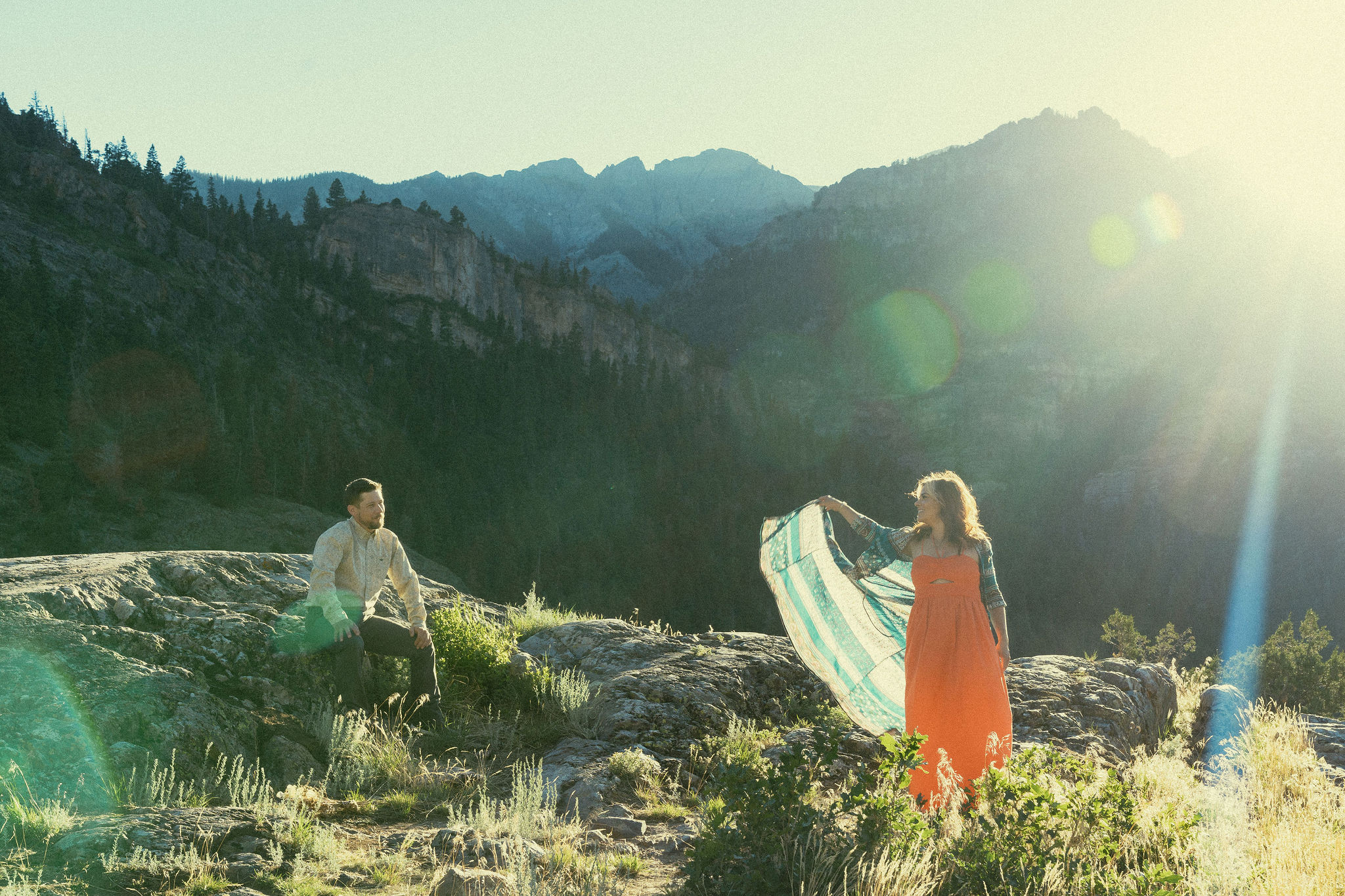 beautiful couple pose during their Ouray engagement photos with the Rocky mountains outside Ouray, Colorado