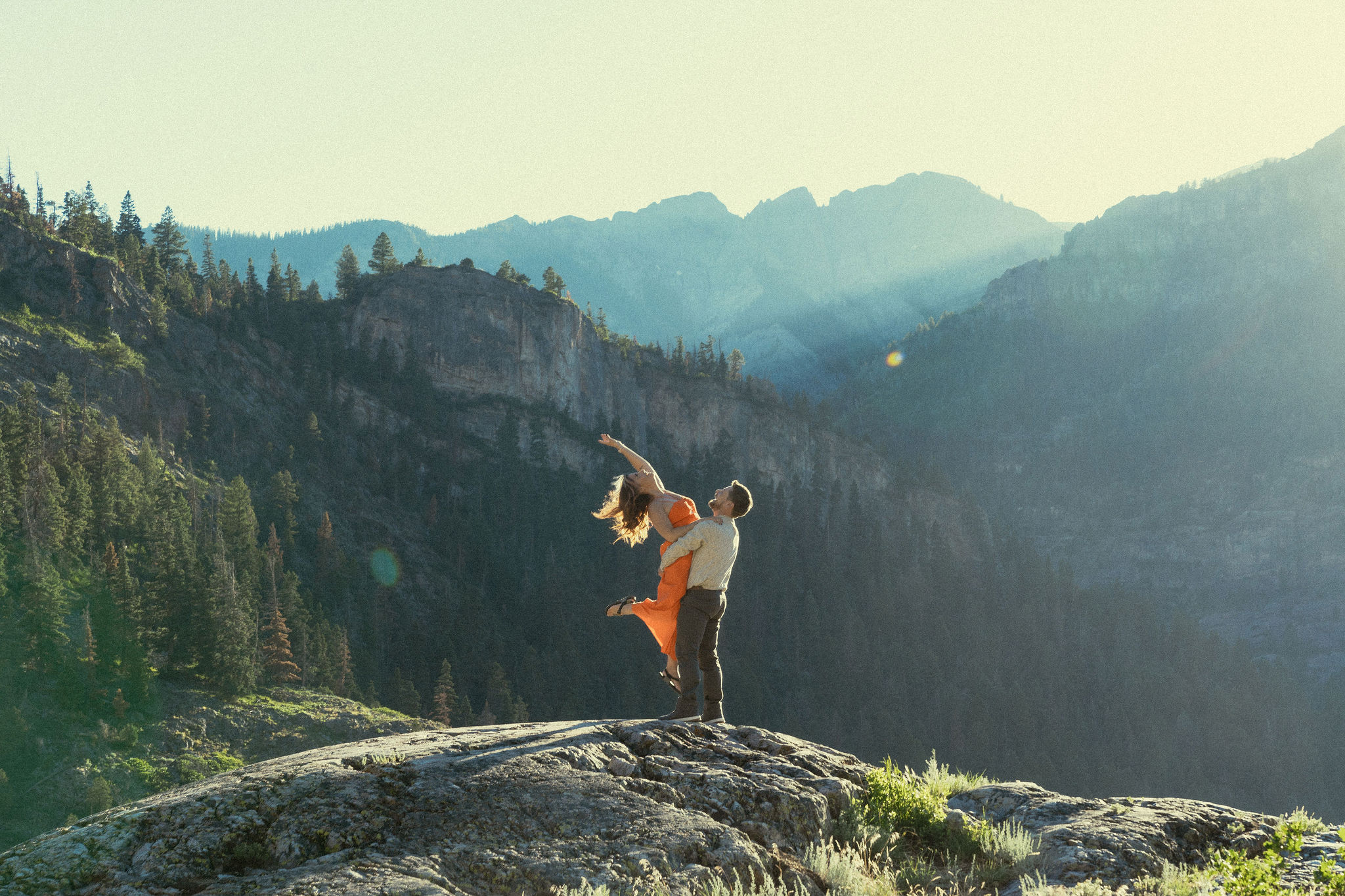 beautiful couple pose during their Ouray engagement photos with the Rocky mountains outside Ouray, Colorado