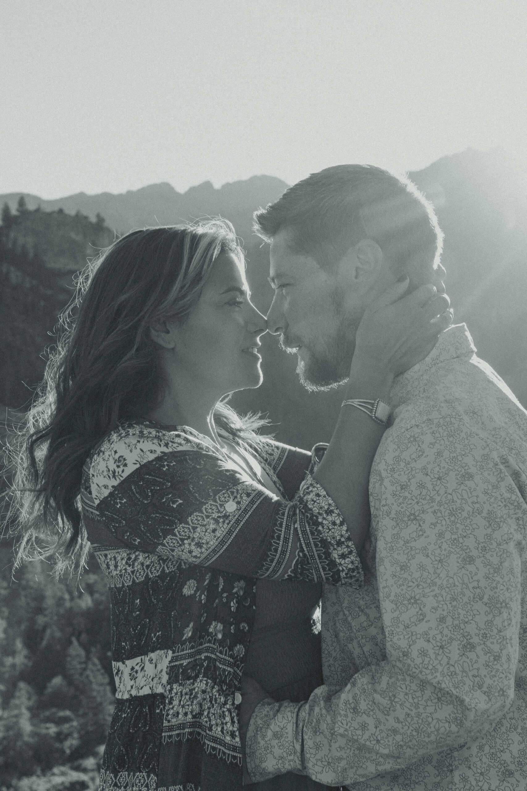 beautiful couple pose during their Ouray engagement photos with the Rocky mountains outside Ouray, Colorado