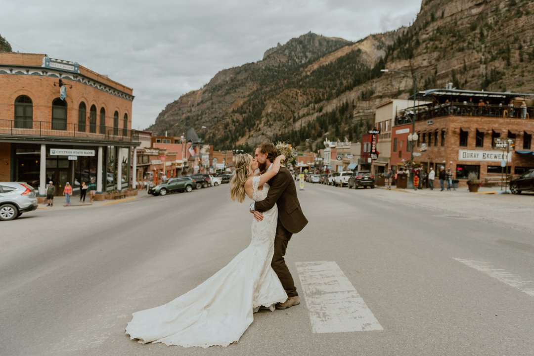 beautiful bride and groom pose in Ouray, Colorado for a photo