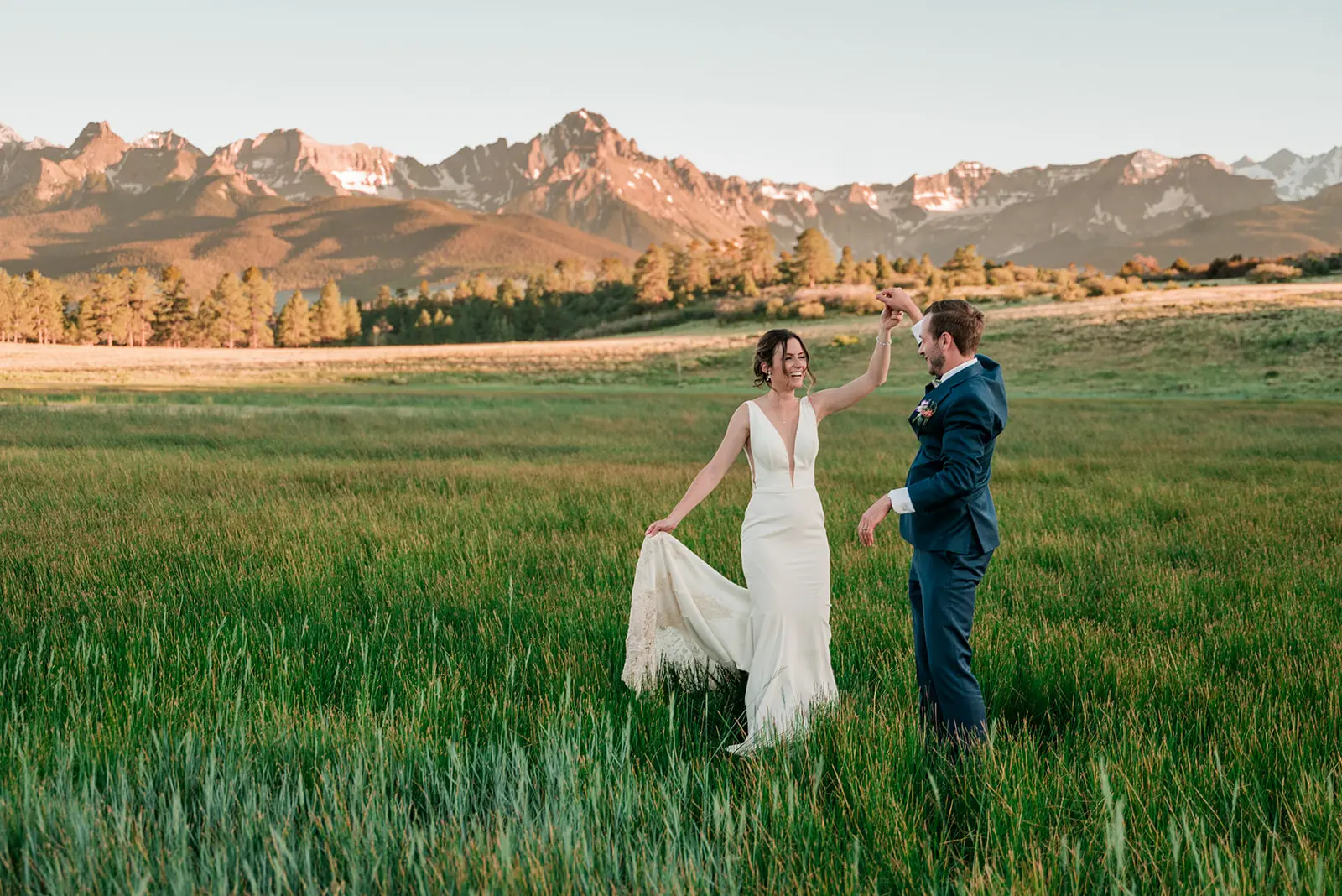 beautiful bride and groom pose in the Rocky Mountains outside Ouray, Colorado for a photo