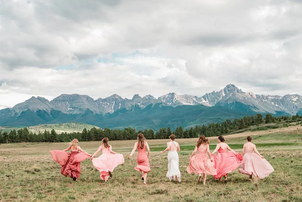 beautiful bridesmaids pose in the Rocky Mountains outside Ouray, Colorado for a photo