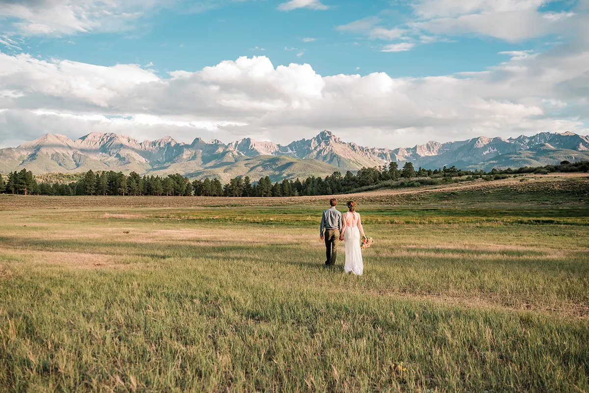 beautiful bride and groom pose in the Rocky Mountains outside Ouray, Colorado for a photo