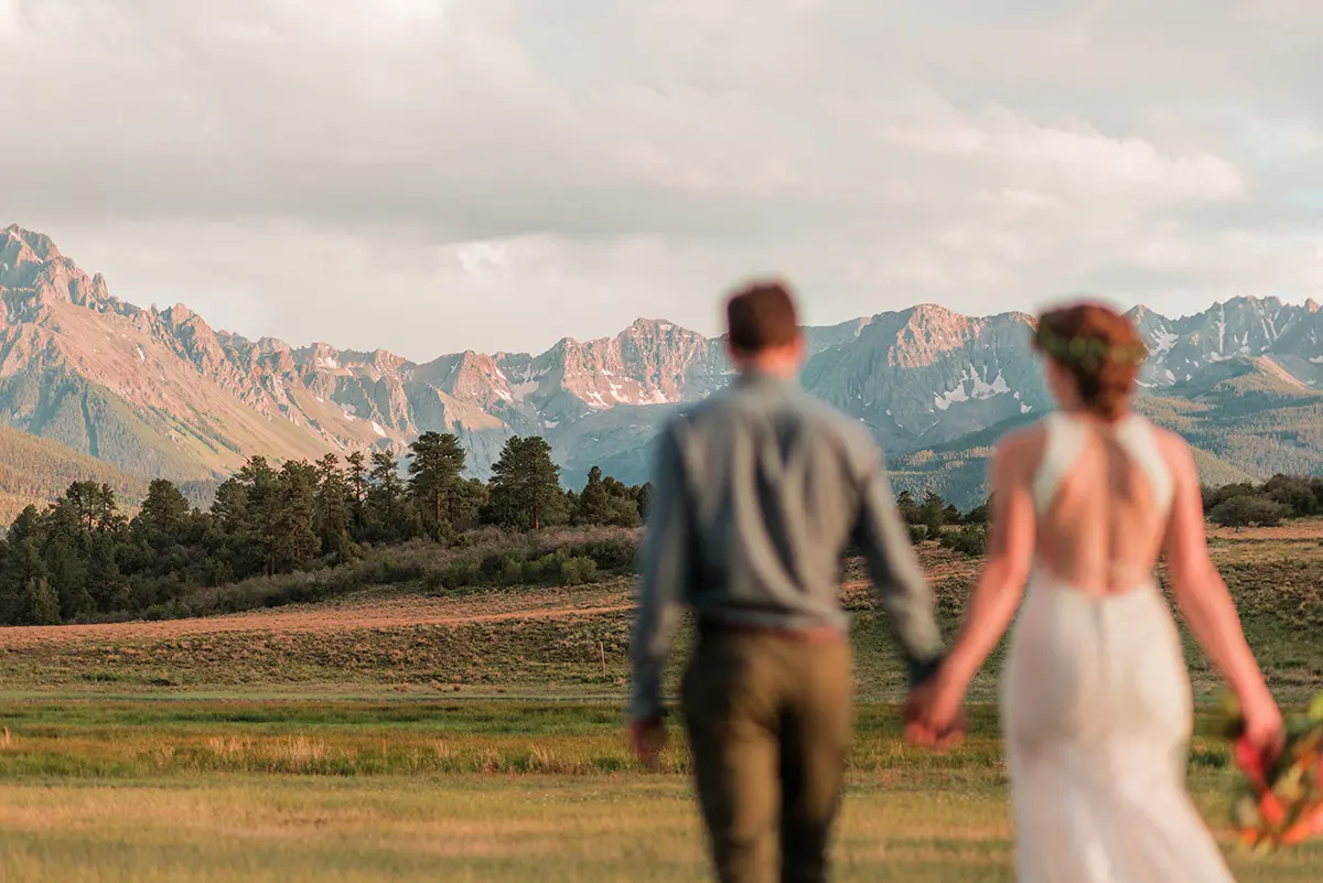 beautiful bride and groom pose in the Rocky Mountains outside Ouray, Colorado for a photo