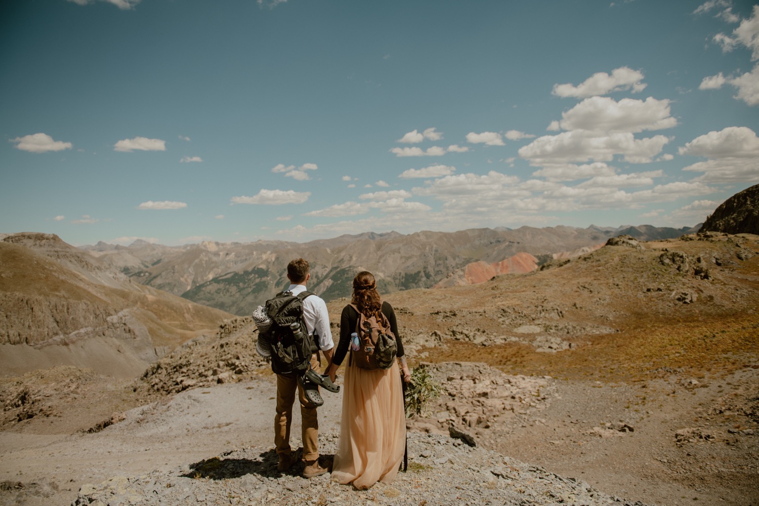 couple poses on the top of imogene pass during their engagement shoot