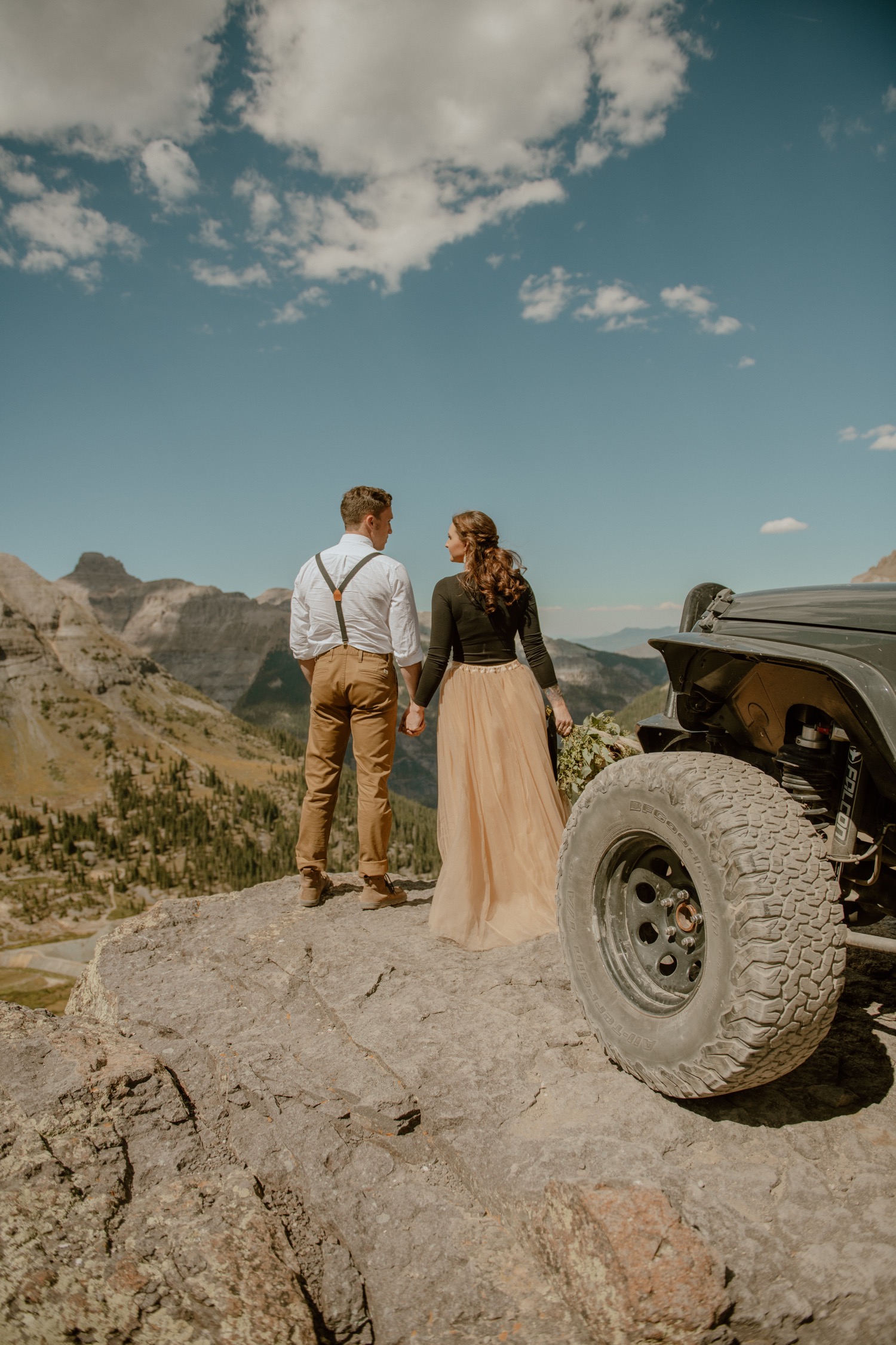 couple poses on the top of imogene pass during their engagement shoot