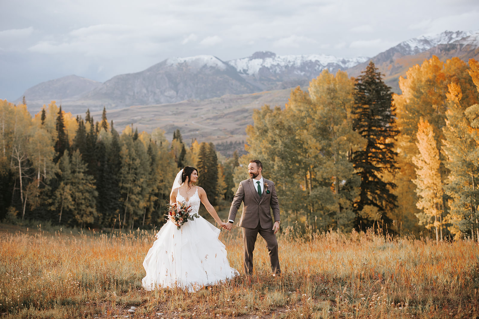 bride and groom pose in the beautiful Colorado nature 