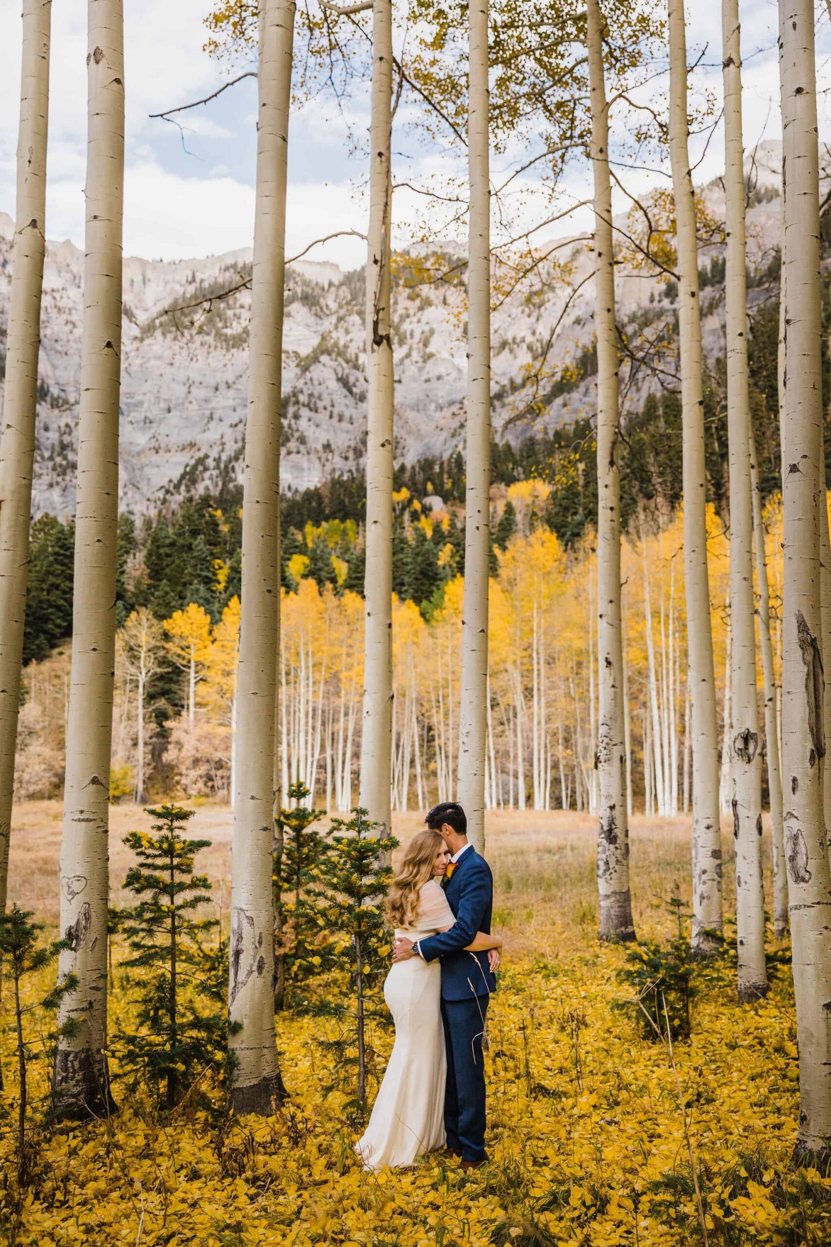 bride and groom pose in Colorado forrest!