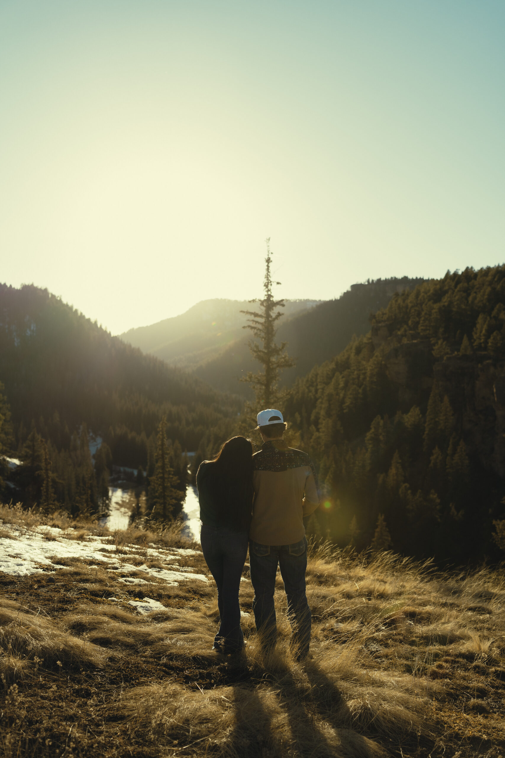 beautiful couple pose for a photo during their engagement session in nature