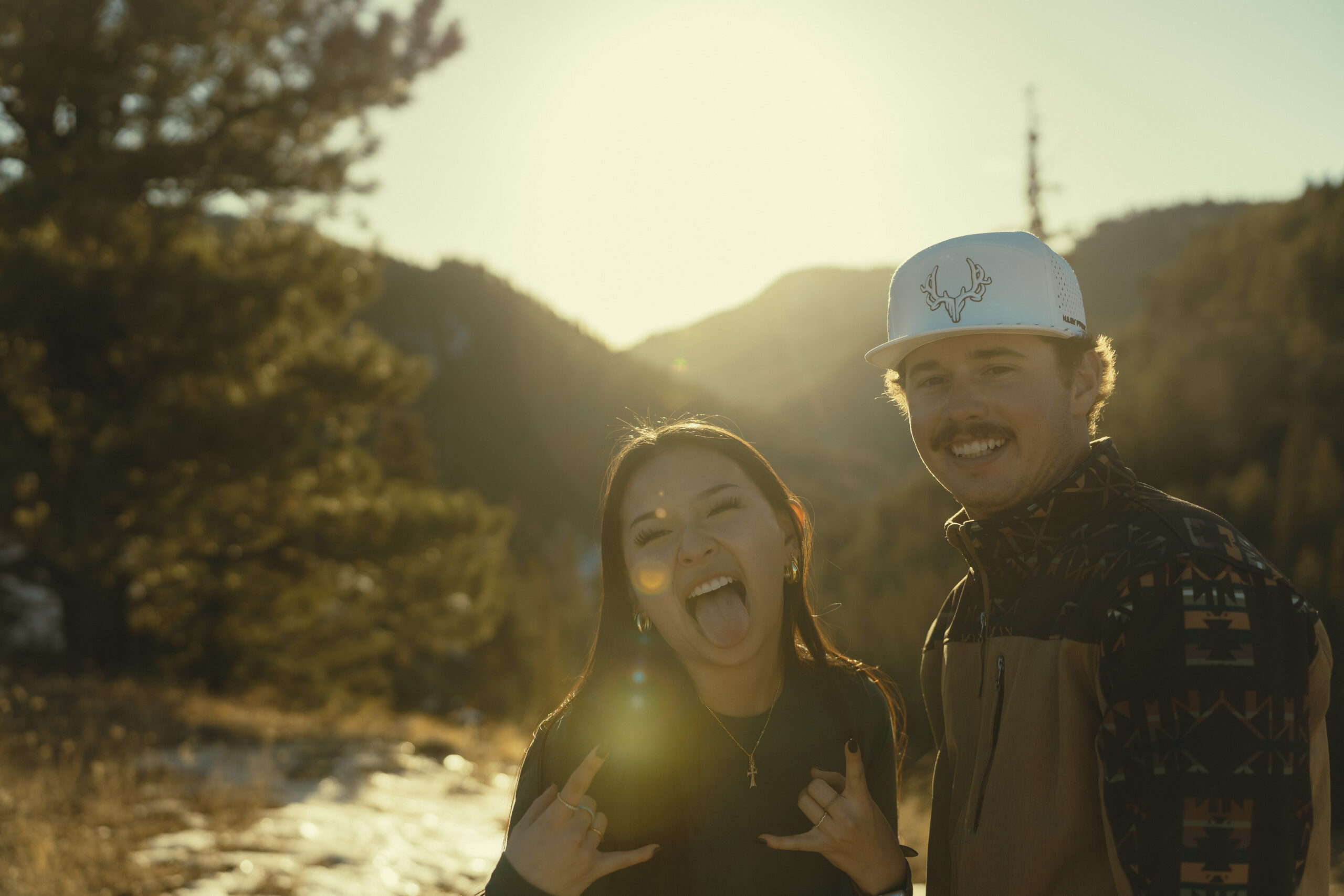 beautiful couple pose for a photo during their engagement session in nature