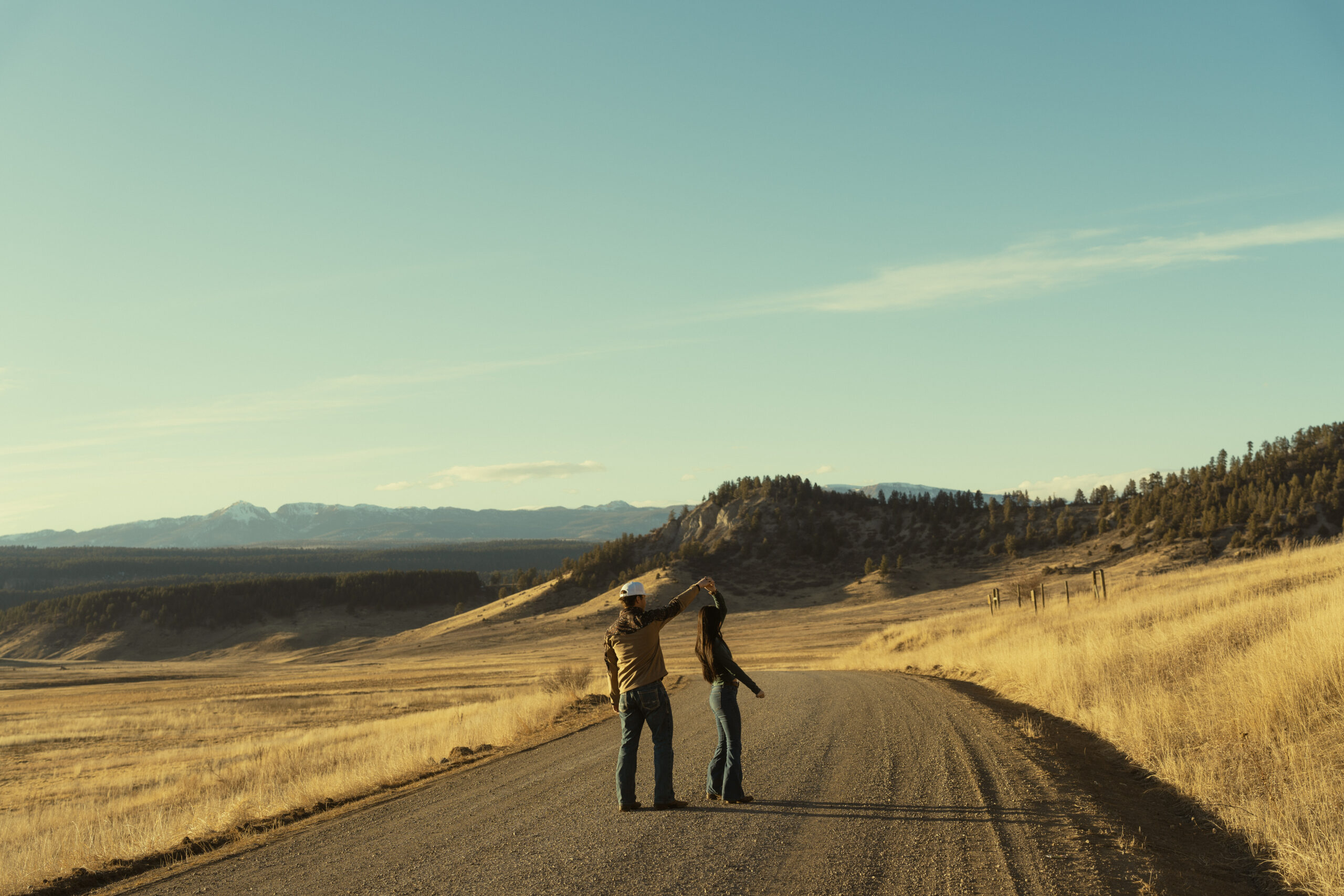 stunning landscape shot with the couple dancing in the foreground