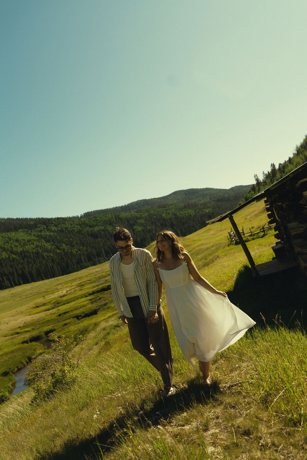 stunning couple walk through the Colorado wilderness during their engagement photoshoot