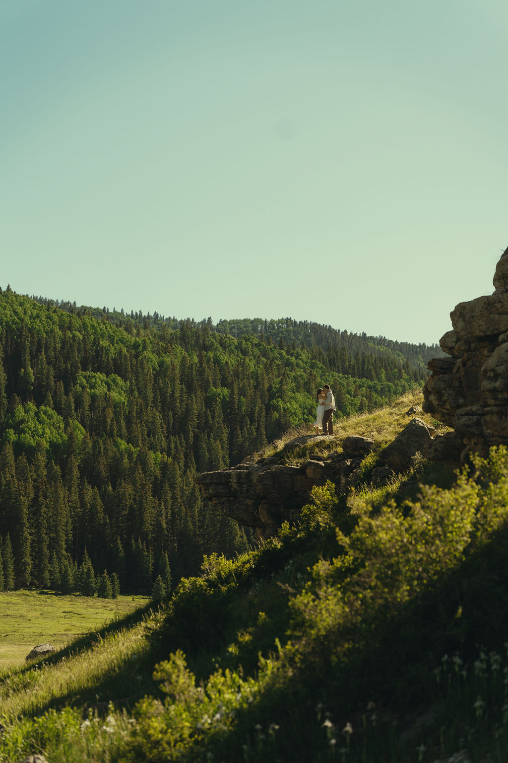 stunning couple walk through the Colorado wilderness during their engagement photoshoot
