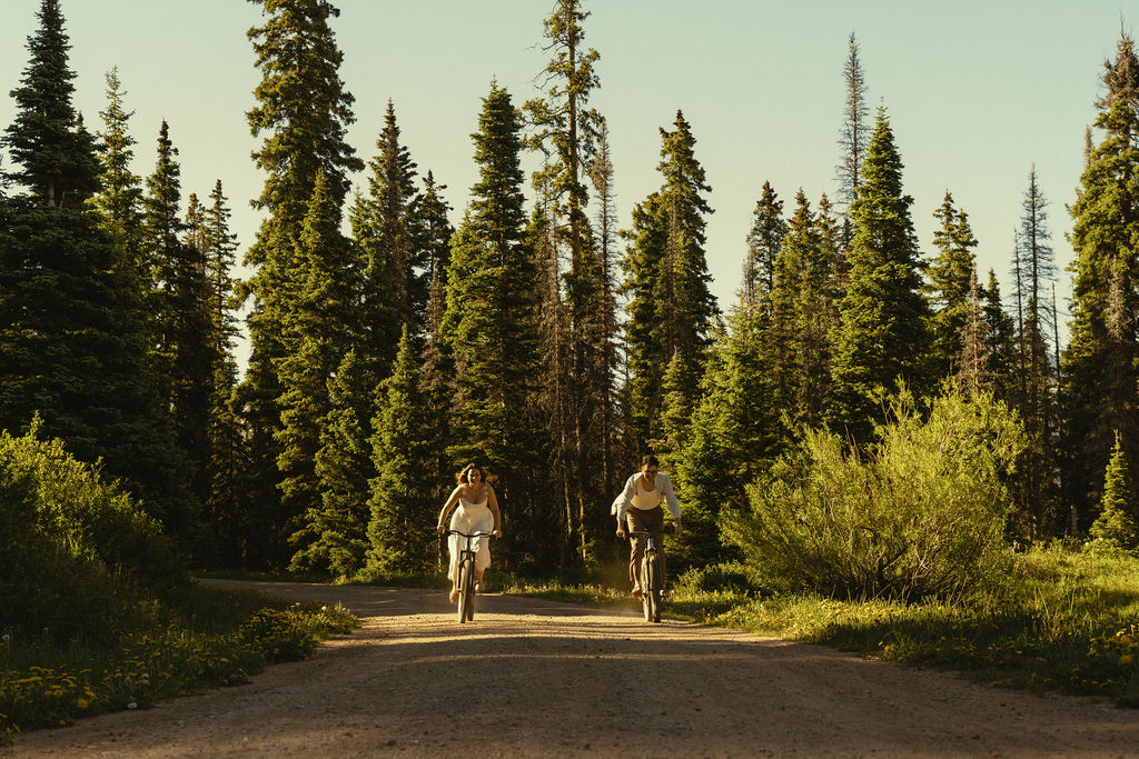 couple take a bike ride together down a country Colorado road during their Durango engagement photos