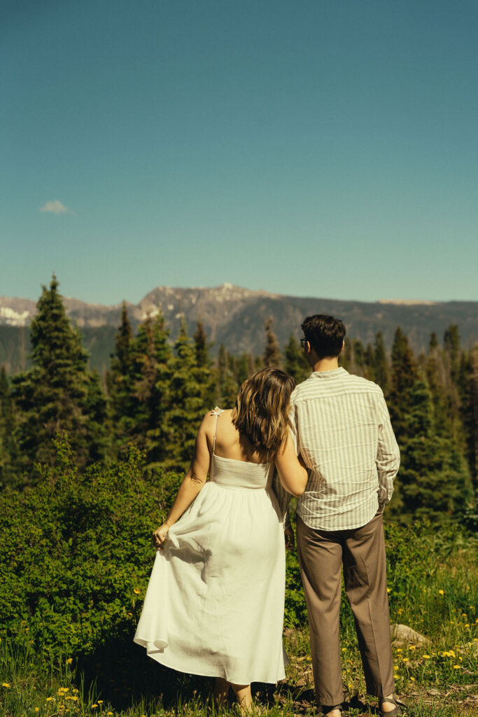 stunning couple look over the Colorado mountains together during their Durango engagement photos