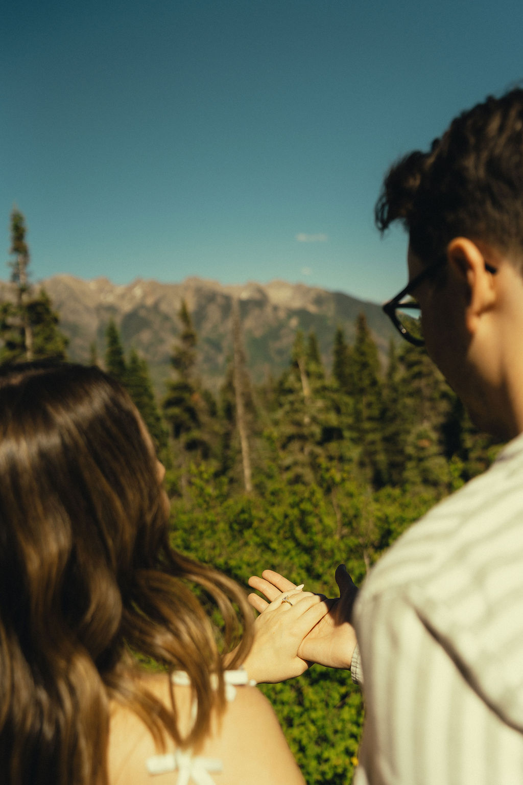 beautiful couple look over the Colorado mountains during their dreamy engagement photo session
