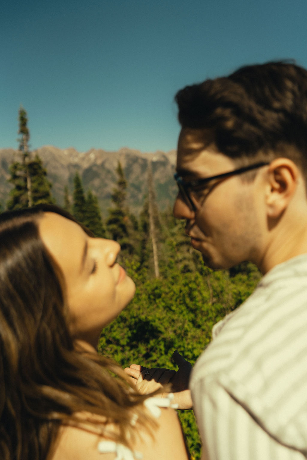 beautiful couple look over the Colorado mountains during their dreamy engagement photo session