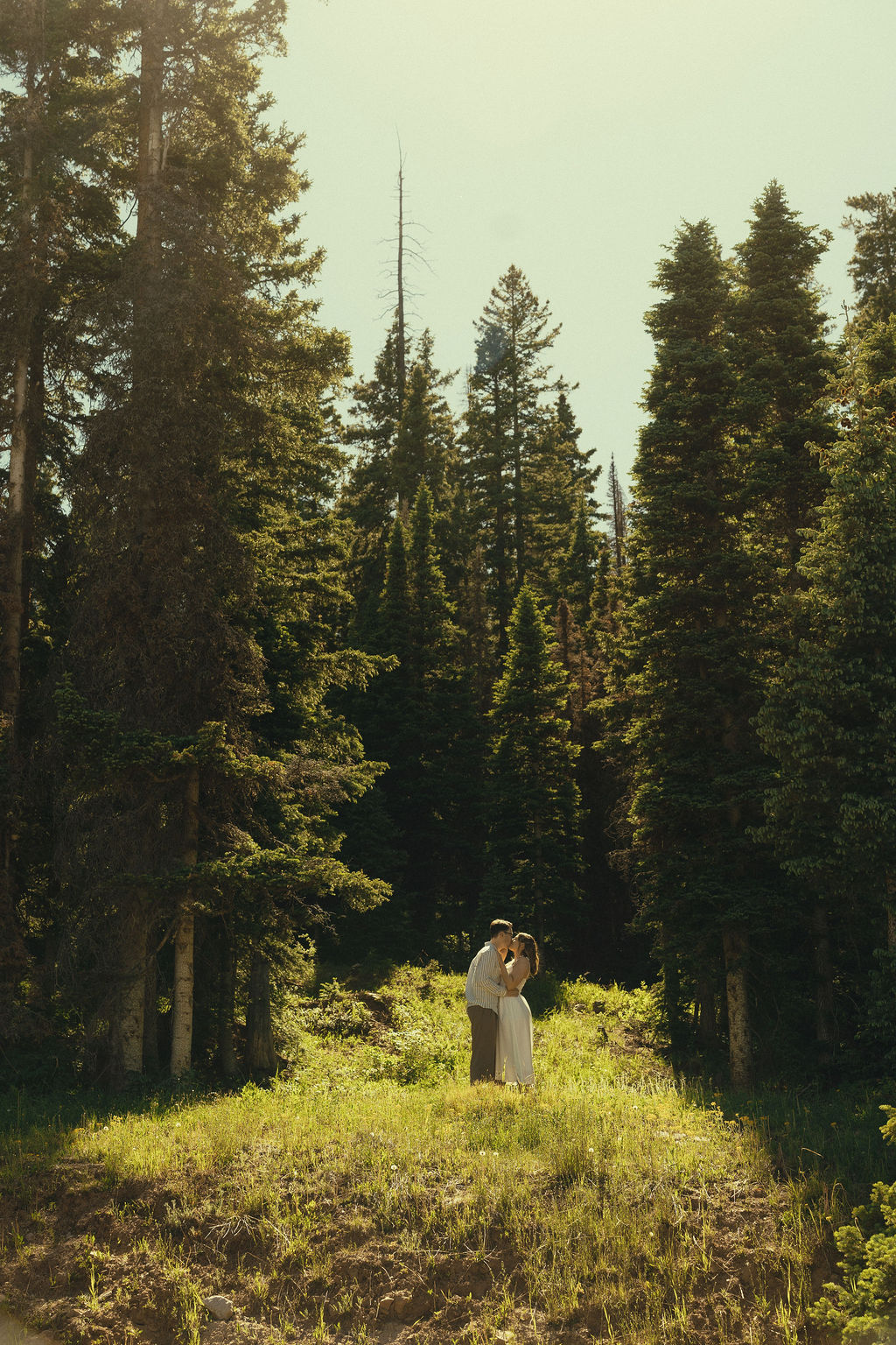 stunning couple share intimate moments in the woods during their engagement photos in Durango