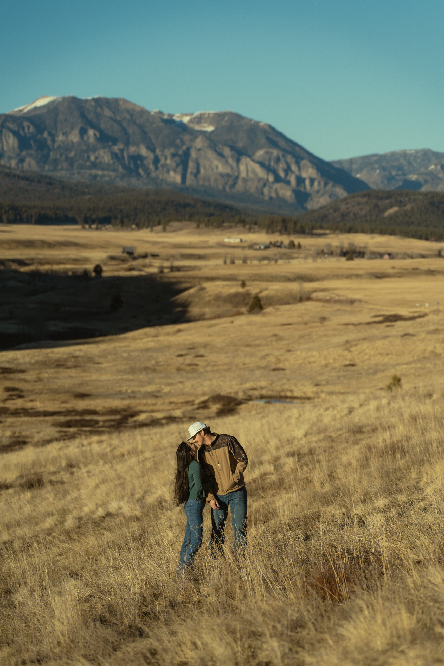stunning couple share an intimate moment during their mountain engagement photos