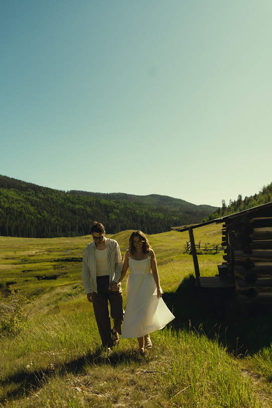 beautiful couple take a walk in the Colorado mountains during their engagement session