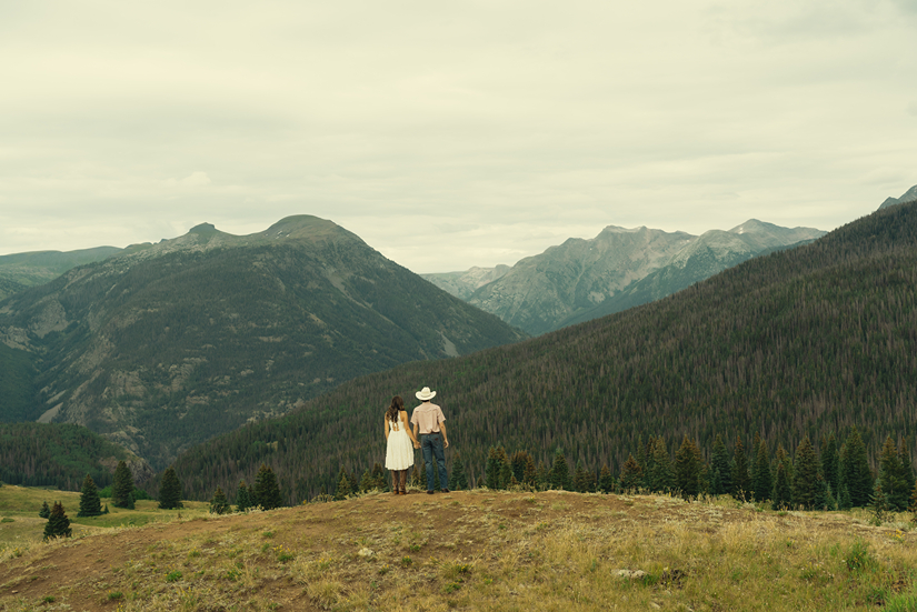 beautiful couple pose together during their stunning engagement shoot in Silverton, Colorado  with the mountains in the background