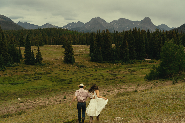 beautiful couple frolick in the Colorado nature during their engagement photos