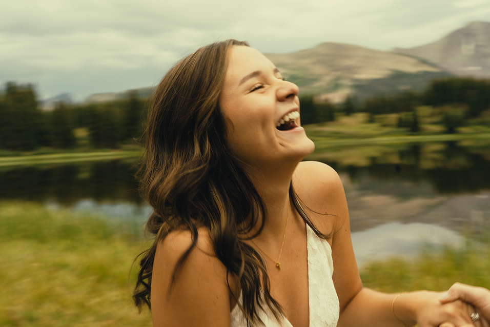 candid photo a future bride during her romantic engagement photoshoot in Colorado