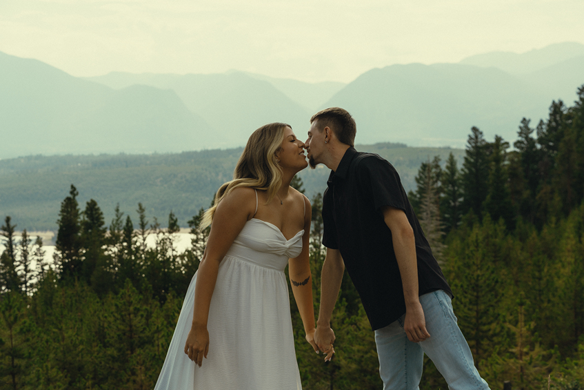 beautiful couple share a kiss during their mountain engagement photos with Sasha Takes Pictures