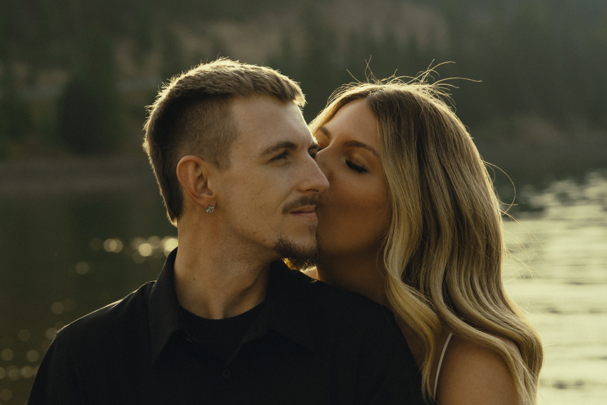 beautiful couple share a kiss during their engagement session