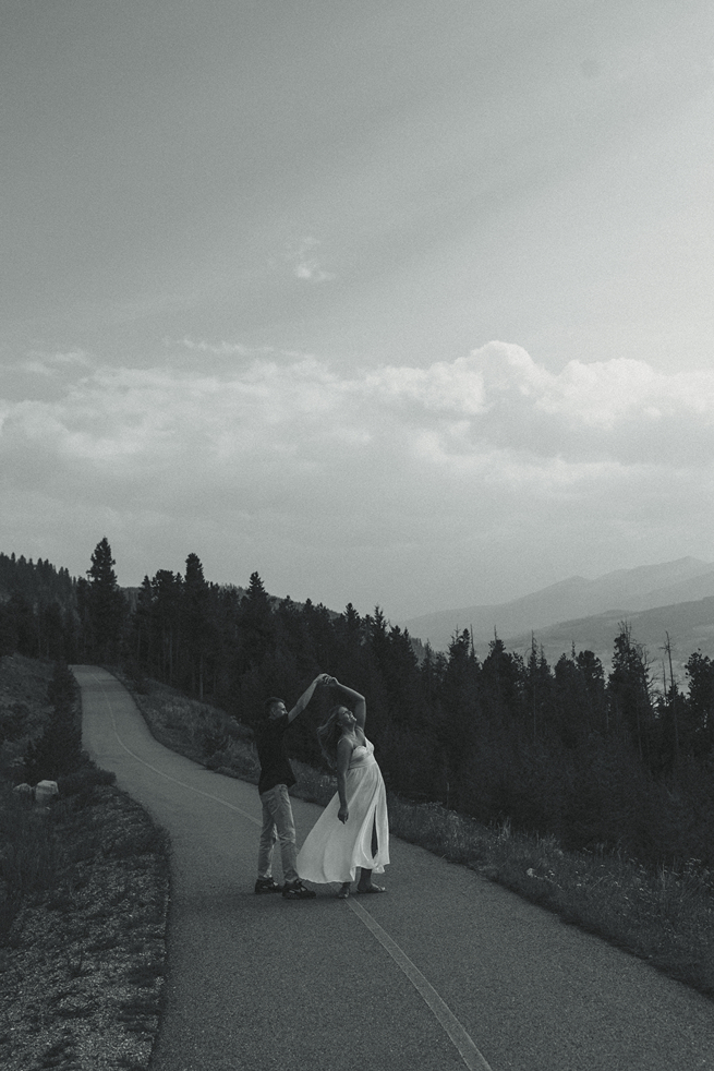couple dances together with the Colorado nature in the background