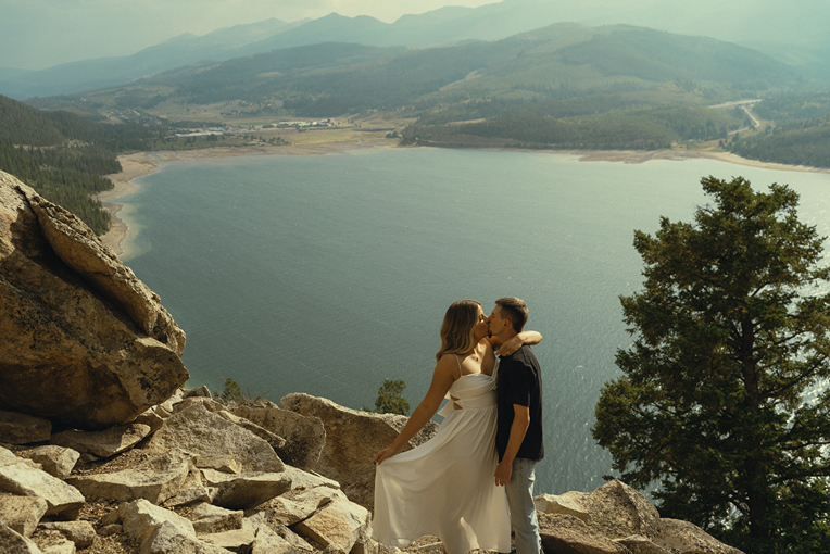 beautiful couple share a kiss during their mountain engagement photos with Sasha Takes Pictures