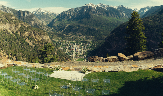 stunning wedding ceremony site sits overlooking the Colorado town with the mountains in the background