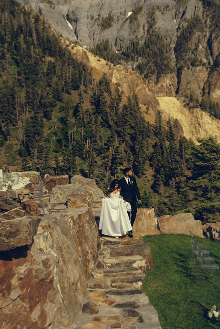 bride and groom pose with the San Juan mountains in the background