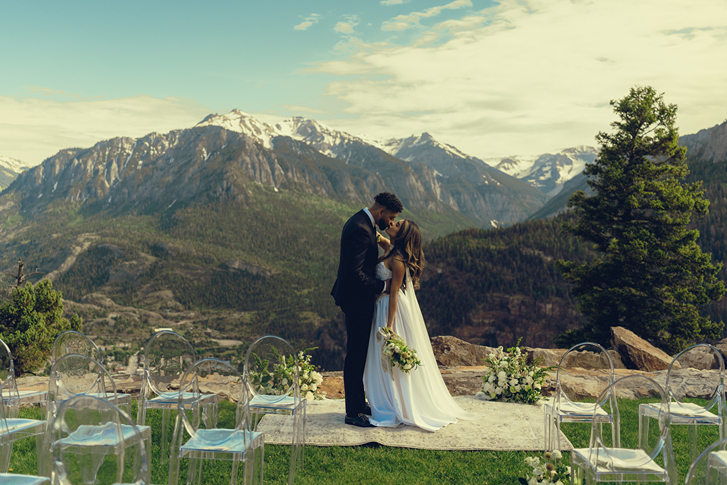 stunning wedding ceremony site sits overlooking the Colorado town with the mountains in the background