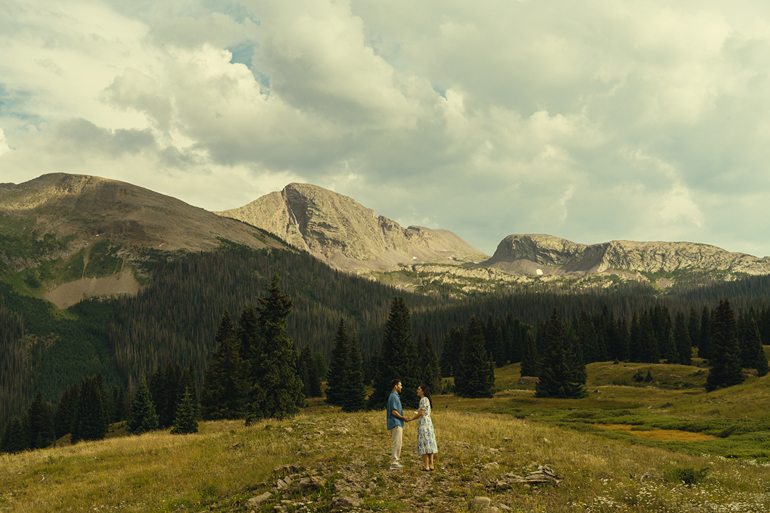 couple share an intimate moment along the meadows in the San Juan mountains