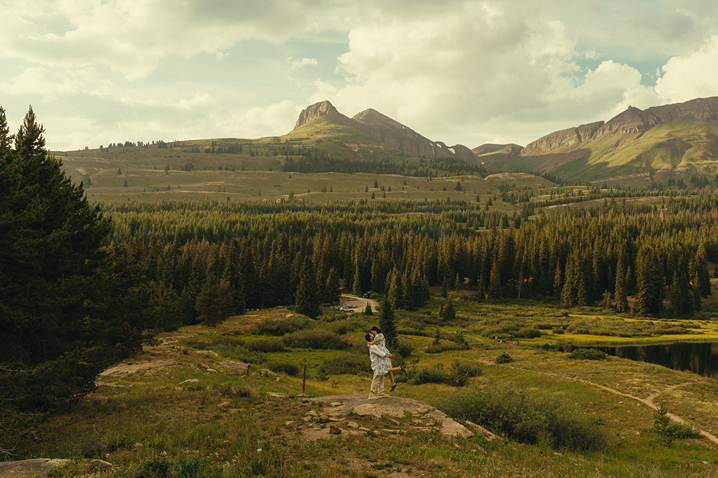 couple share an intimate moment along the meadows in the San Juan mountains
