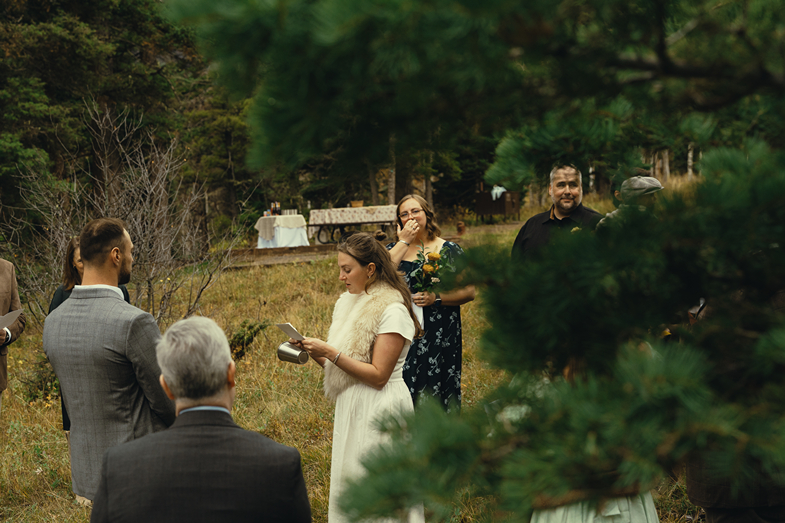 outdoor wedding ceremony takes place in the rocky mountains