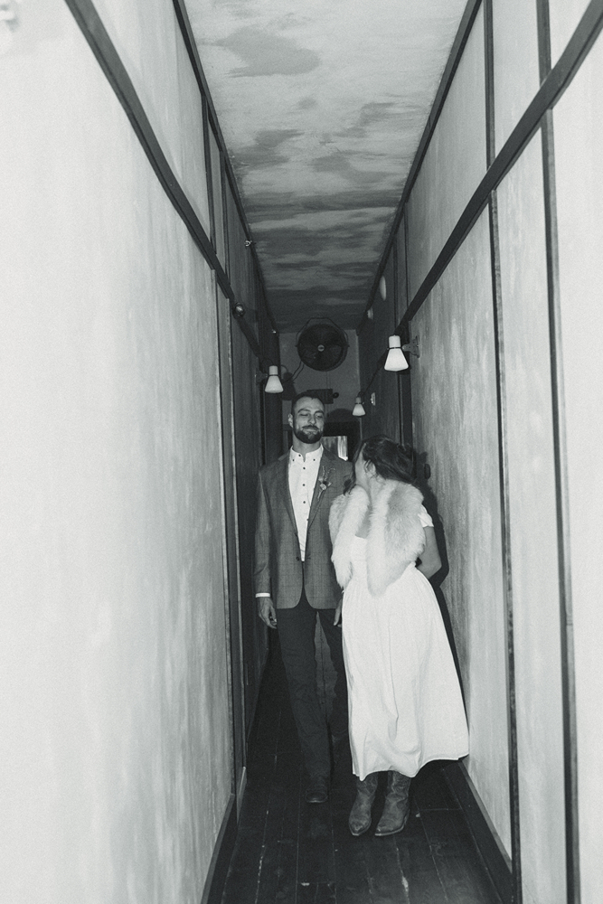 stunning bride and groom walk through the hallway at a Western hotel during their Colorado wedding day