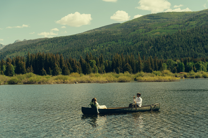 bride and groom ride in the canoe together during their Colorado elopement
