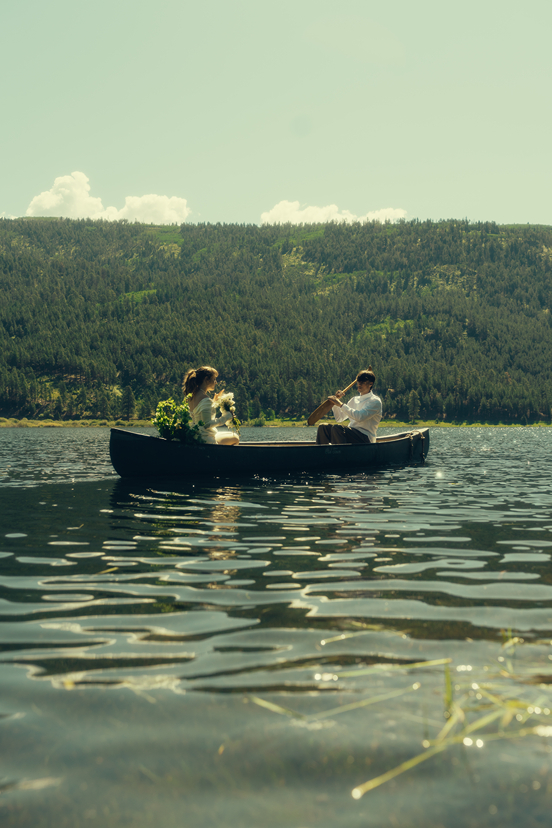 bride and groom ride in the canoe together during their Colorado elopement