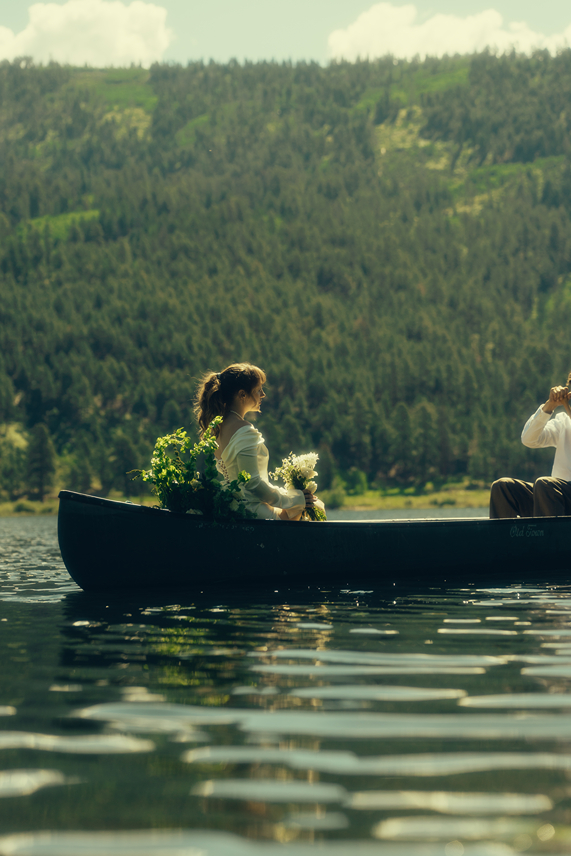bride and groom ride in the canoe together during their Colorado elopement