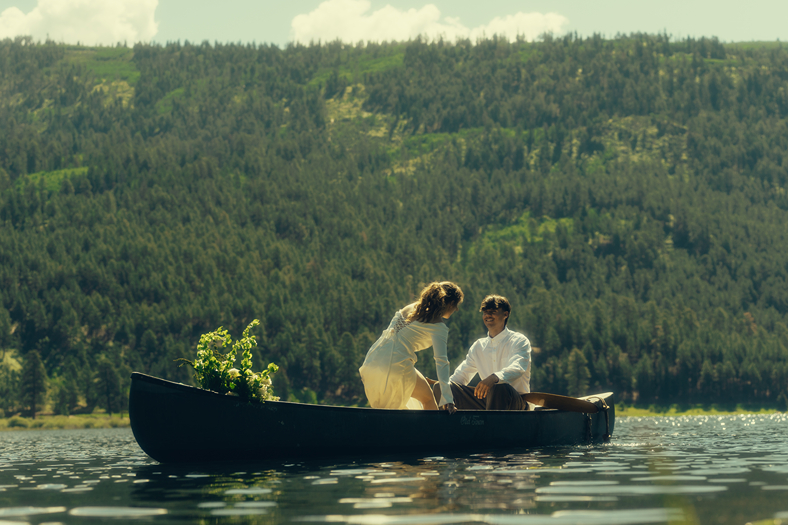 bride and groom ride in the canoe together during their Colorado elopement