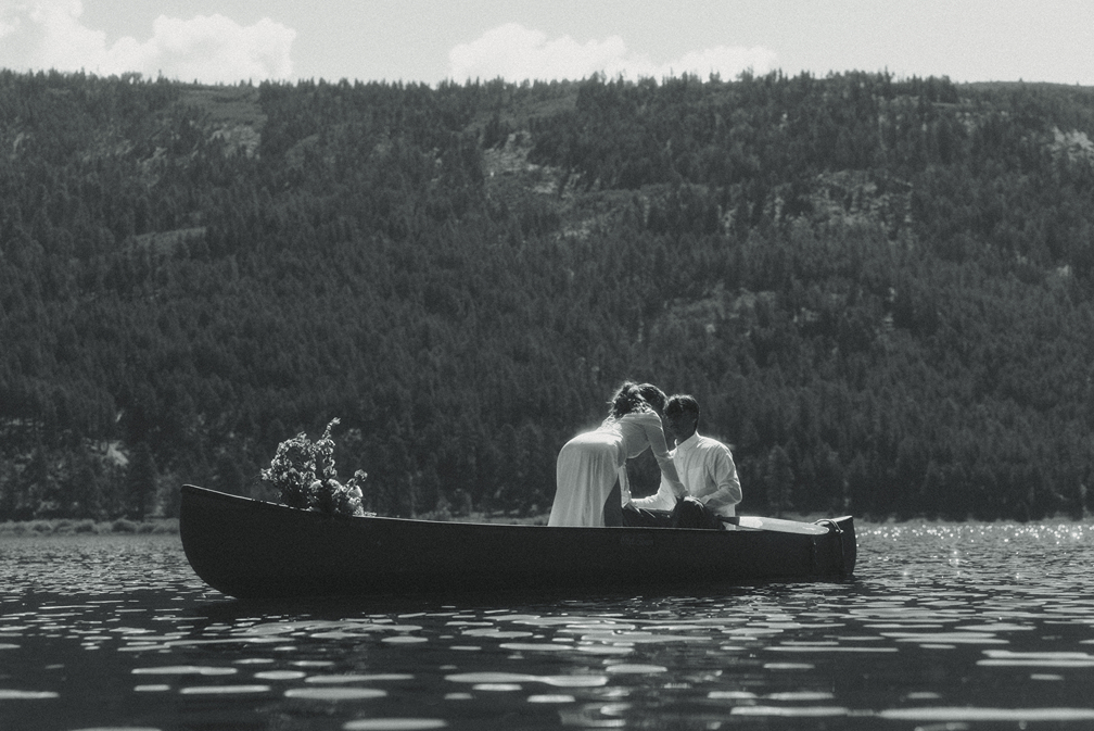 bride and groom ride in the canoe together during their Colorado elopement